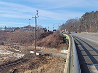 Looking from existing Station 46 Bridge at temporary utility pad where the utility pole will be temporarily relocated to during construction.